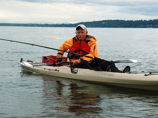 Photo of a man kayak fishing with a downrigger