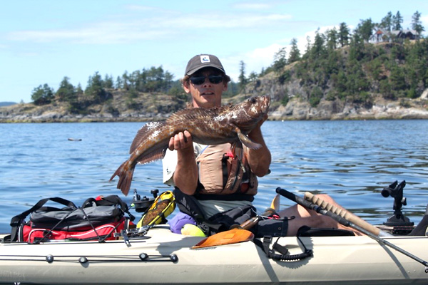 Photo of kayak fishing guide showing a ling cod he has caught