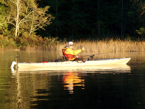 Photo of a fisherman sitting in his kayak fishing