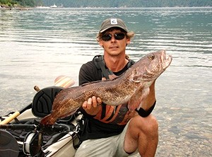Photo of kayak fishing guide Howard holding up a nice ling cod